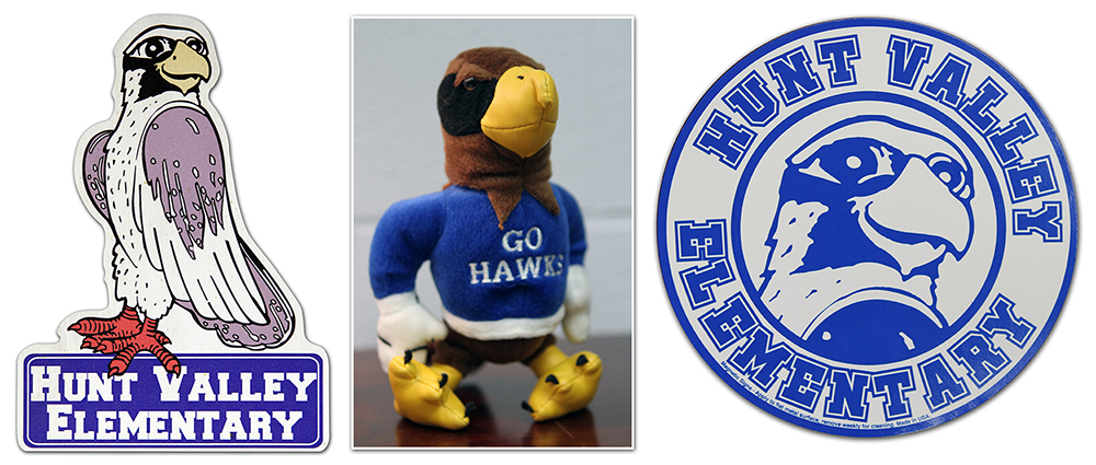 Photograph showing three versions of the hawk mascot as it appeared in different time periods.