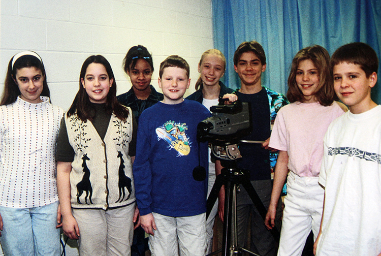 Photograph of students with a video camera.